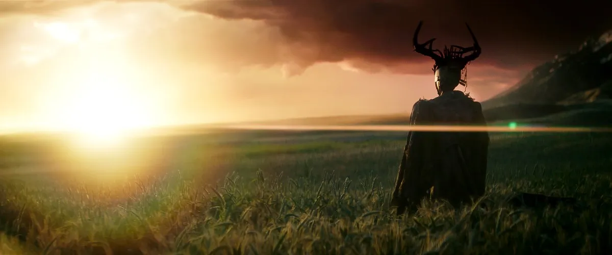 Jimmy, a robot wearing antlers, stands in a field in 'Rebel Moon Part One: A Child of Fire.'