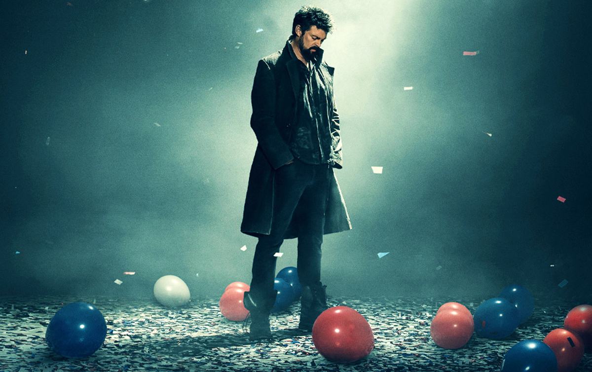 A man walks in a room with balloons and confetti on the floor in 'The Boys' promo image. 