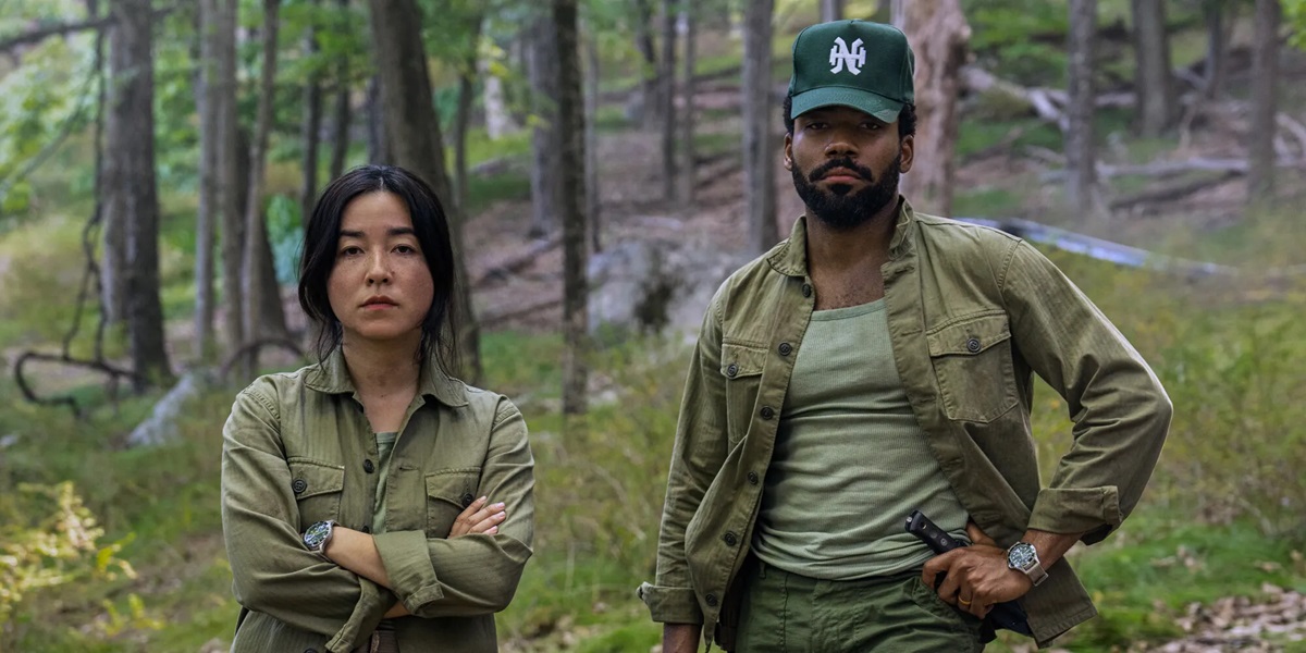 Maya Erskine and Donald Glover looking disgruntled outdoors in Mr. & Mrs. Smith