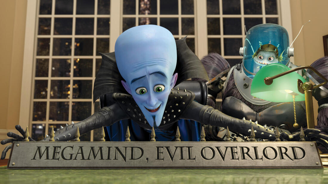 Megamind and his minion (Minion) at his new desk with a nameplate that reads "Megamind, Evil Overlord."