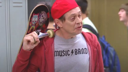 Steve Buscemi wears a backwards baseball capo and carris a skateboard in this image from '30 Rock'.