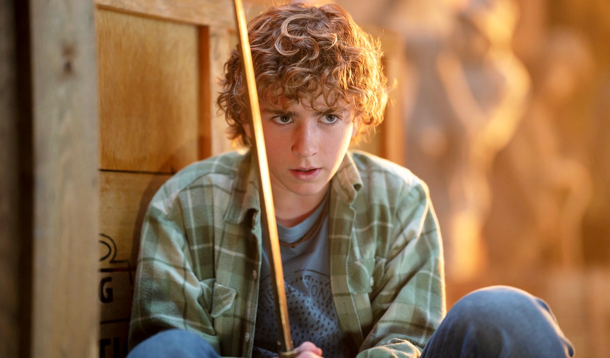 Walker Scobell holding Riptide in Percy Jackson and the Olympians