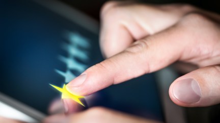 A closeup of a hand clicking one star out of five on a tablet.