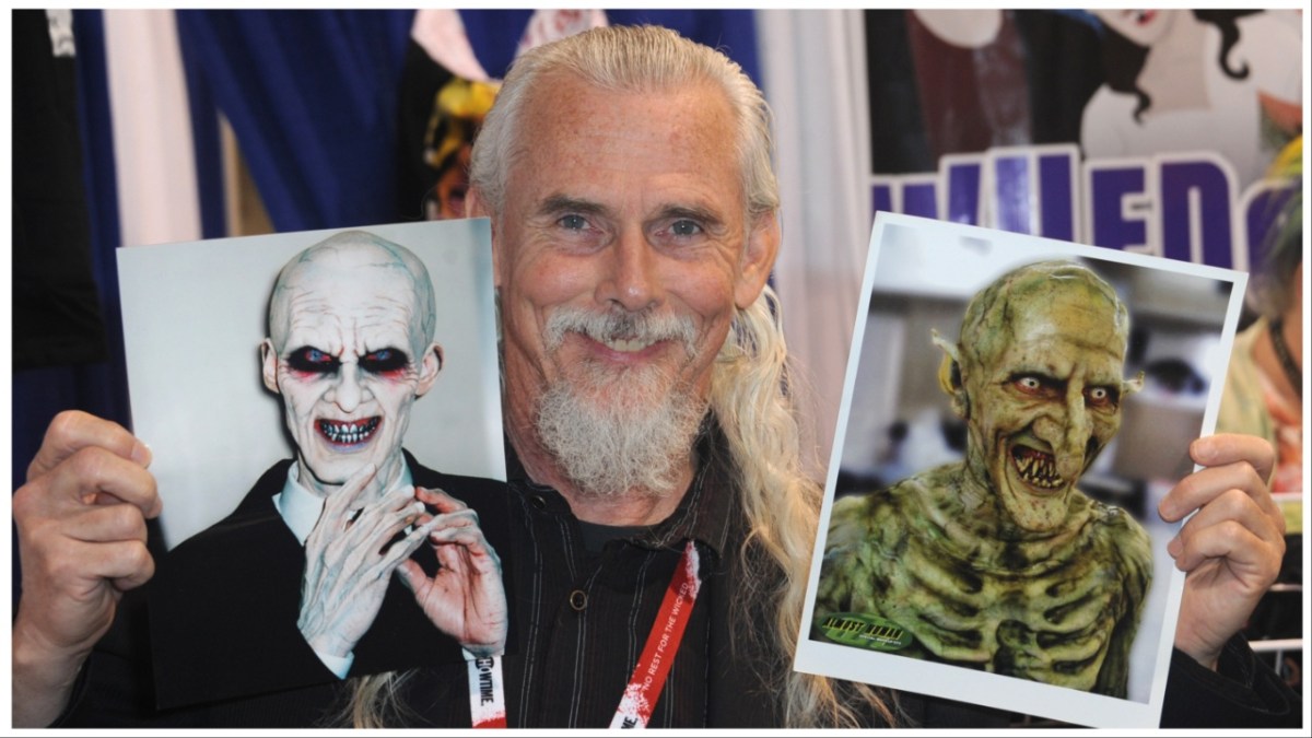Camden Toy holds up headshots of two monsters he's played, the Gentleman and Fyarl, at WonderCon.