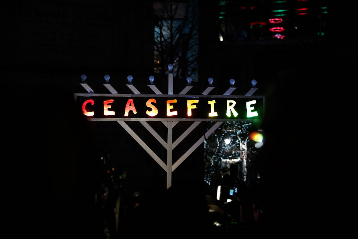 An oversized menorah with the word "ceasefire" written on it.