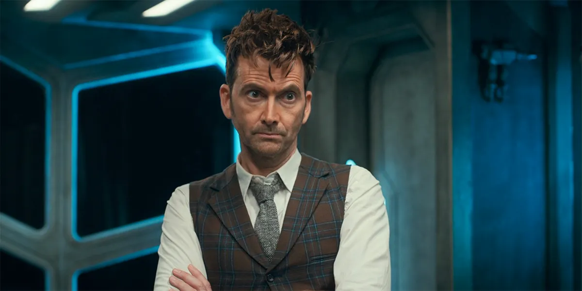David Tennant, a man with red hair in a vest, shirt, and tie, looking concerned in 'Doctor Who'.