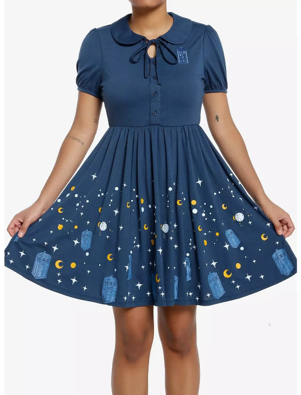 A blue dress with a flared skirt. The skirt has a pattern of Tardis', suns, moon, and stars on it.