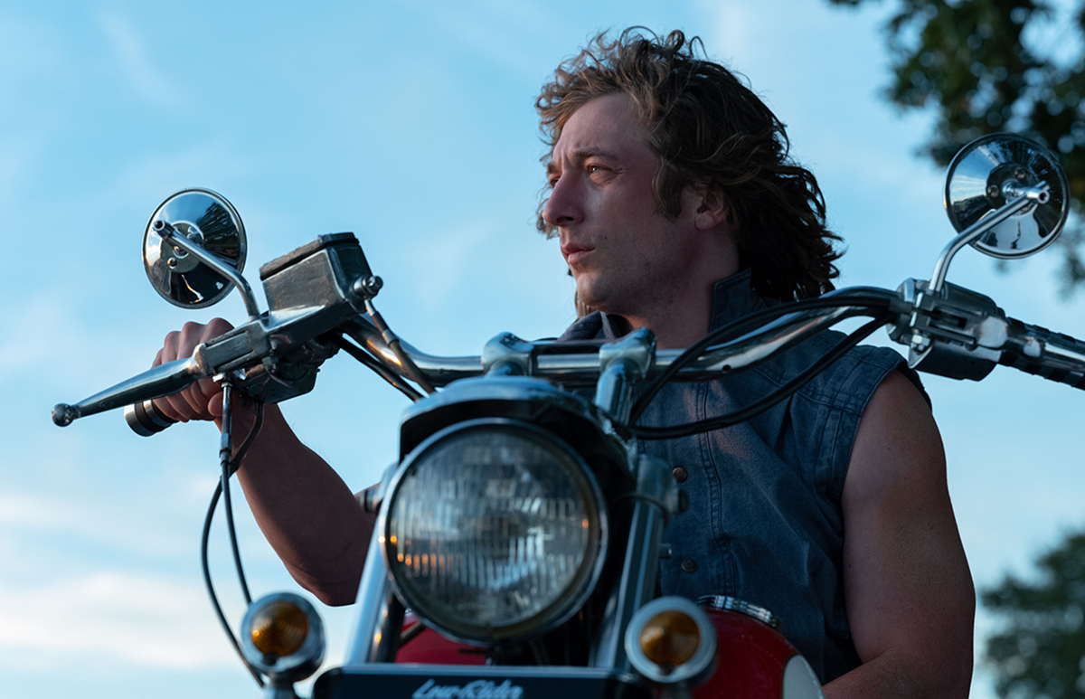 Jeremy Allen White on a motorcycle looking to the side