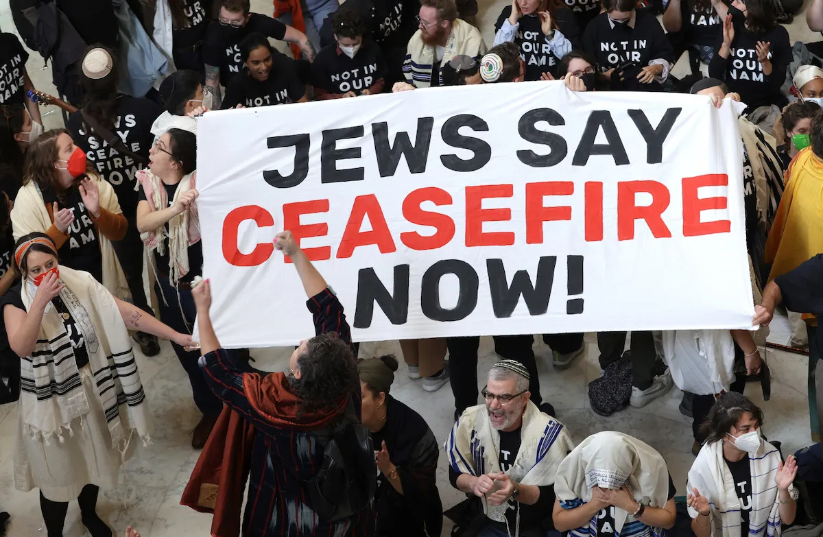 Jews hold up a banner that says "Jews say ceasefire now!" in the U.S. Capitol Building.