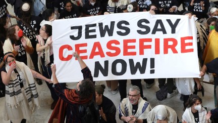 Jews hold up a banner that says 