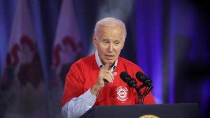Joe Biden speaking at a podium, making a pointing hand gesture.