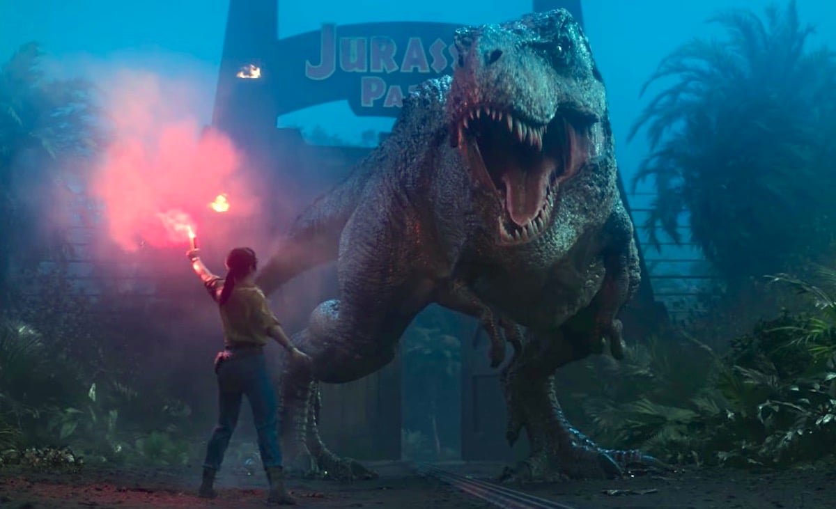 In a scene from Jurassic Park: Survival, a woman holds a flare in front of a roaring T-rex.
