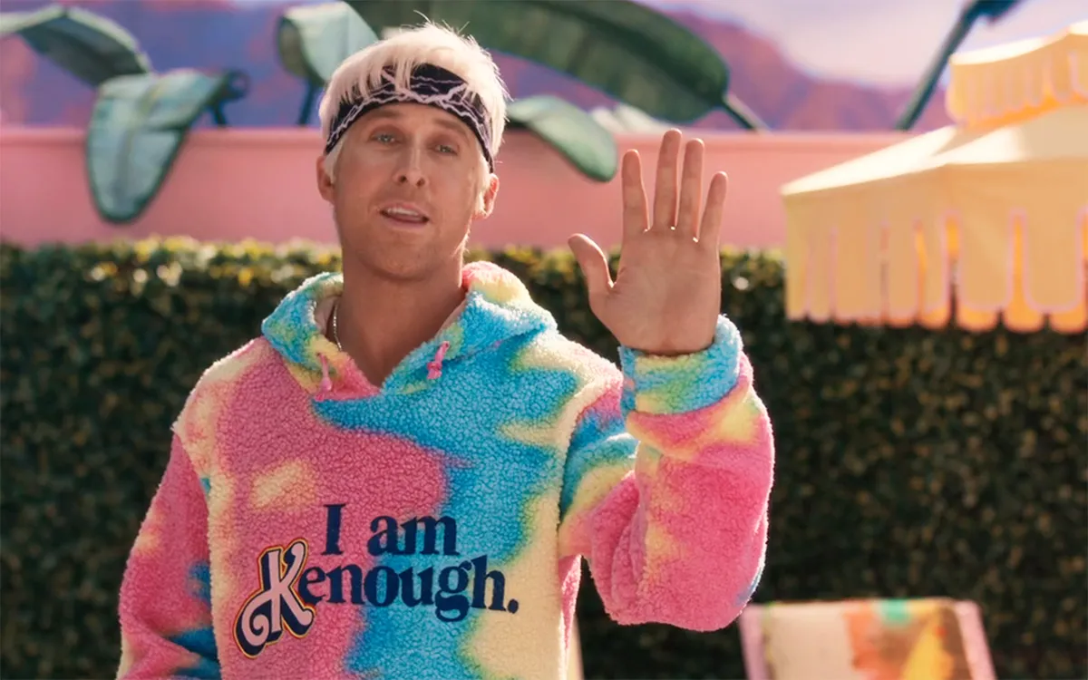 Ryan Gosling waving wearing the "I Am Kenough" sweatshirt