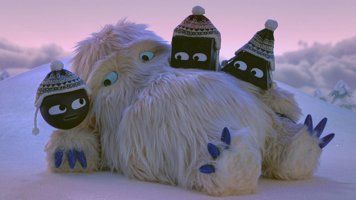 The three shapes on Shape Island gather around a big, white, furry yeti in the snow.