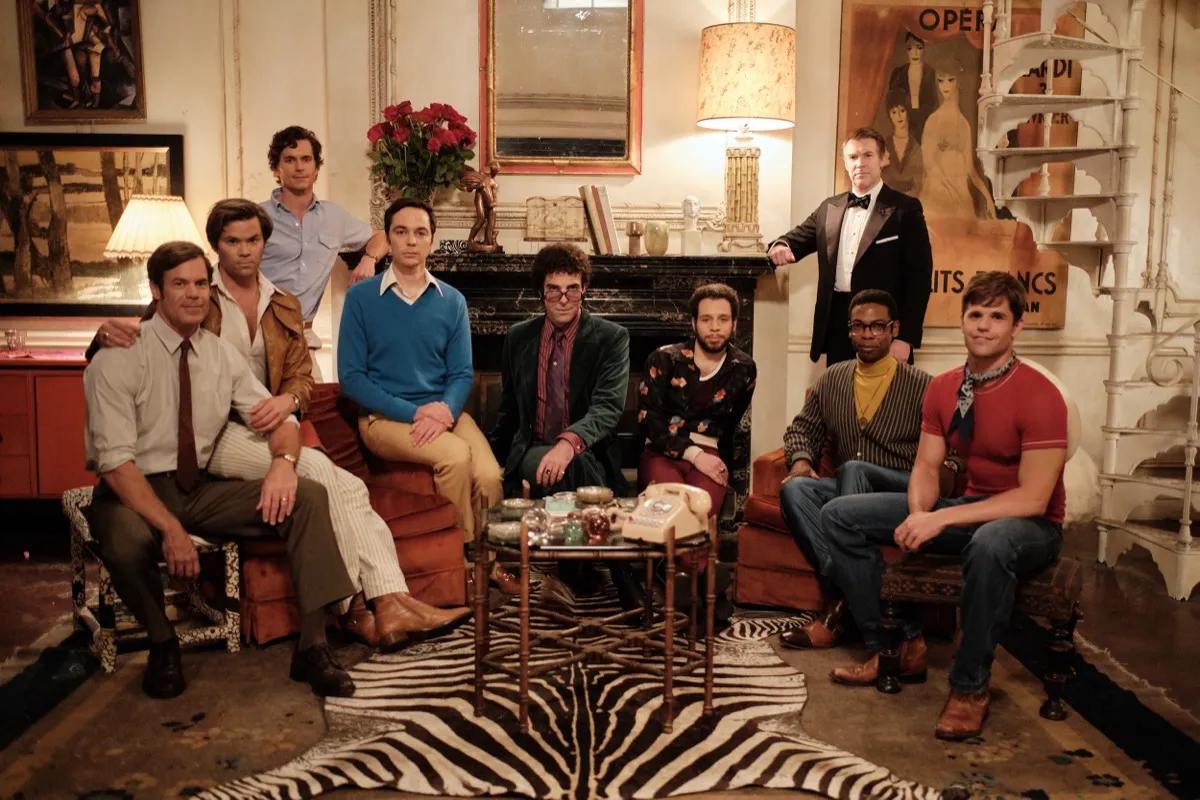 The cast of "The Boys in The Band" sitting in the living room 