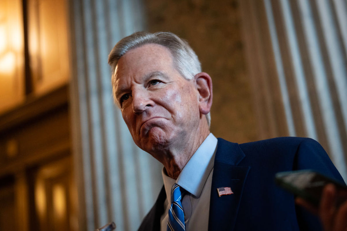 An old white man (Tuberville) gives an exaggerated frown.