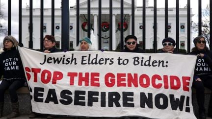 18 elderly Jewish women hold up a banner in front of the White House reading, 
