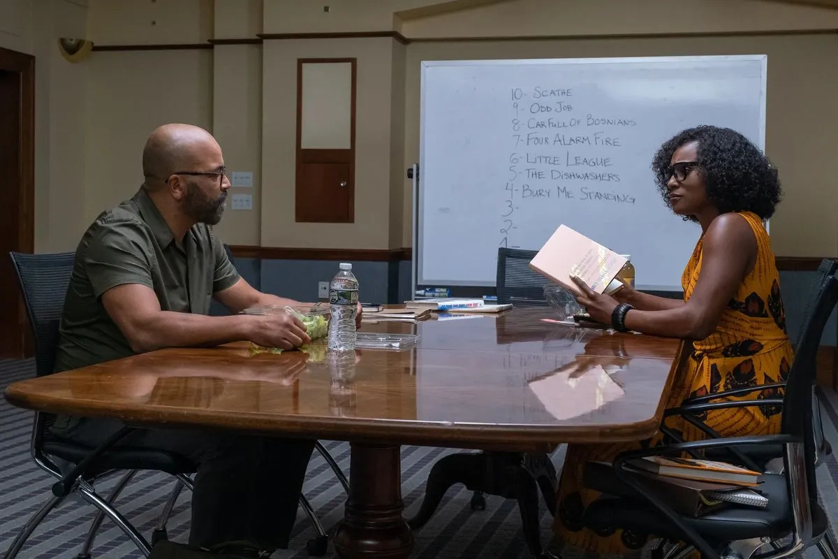 Jeffrey Wright sitting across a table in front of Issa Rae in the film 'American Fiction.'