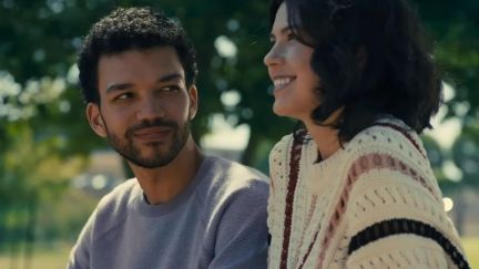 Aren (Justice Smith) looking at An-Li Bogan's character in 'American Society of Magical Negroes.'