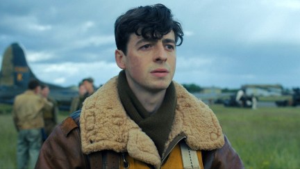 Harry Crosby (Anthony Boyle) stands in a field near planes in 'Masters of the Air.'
