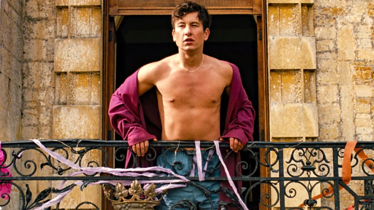 Oliver (Barry Keoghan) stands on the balcony shirtless in 'Saltburn.'
