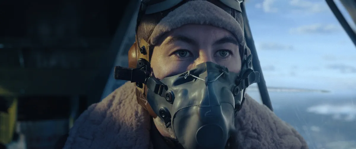 Barry Keoghan wearing fighter pilot mask and hat flying plane in 'Masters Of The Air'