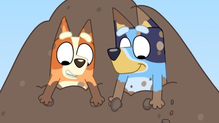 Bluey and Bingo play in a pile of dirt in 'Bluey' Season 3
