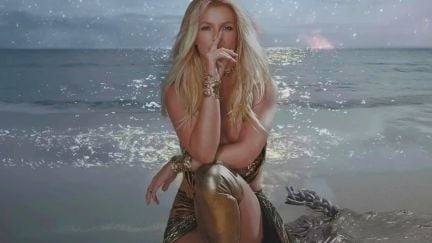 Britney Spears in front of the ocean in the 'Swimming In The Stars' visualizer.