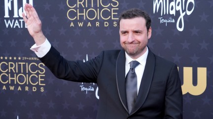 David Krumholtz waving at cameras on a red carpet