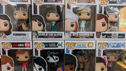 Image of eight Funko Pop figures in their boxes stacked four on four. Top from left to right: Yennifer (The Witcher), Player 067 (Squid Game), Beth Harmon (The Queen's Gambit), Ellie (The Last of Us Part II). Bottom from left to right: Joan Holloway (Mad Men), Death (The Sandman), Uhura (Star Trek), Maeve (Westworld).