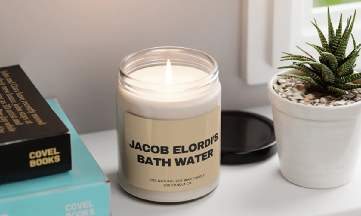 White candle with black text: Jacob Elordi's Bath Water