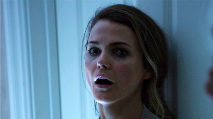 A woman opens her mouth in horror in 'Dark Skies.'
