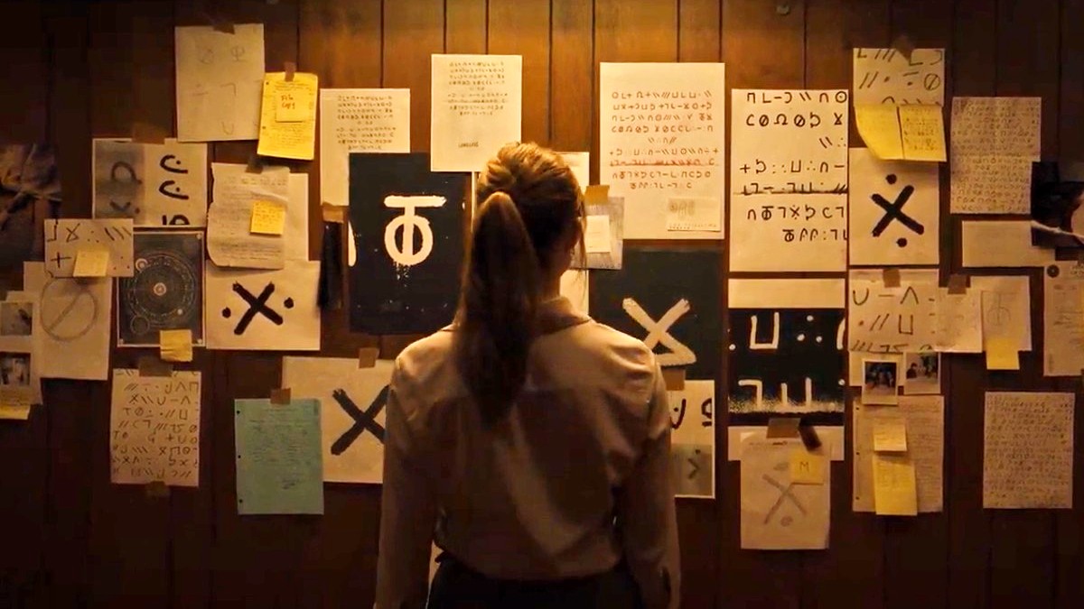 A woman looks at a board of clues in Longlegs