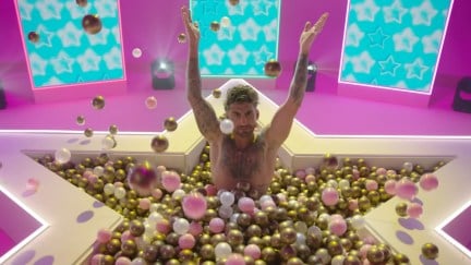 A contestant plays in a ballpit in a promo for 'Love Island: All-Stars'