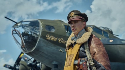 Austin Butler wearing pilot uniform and standing in front of plane as Major Gale Cleven in 