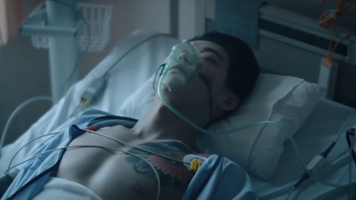 Tokyo Vice season 2 trailer still. Sato lies in a hospital bed with tubes and ventilator