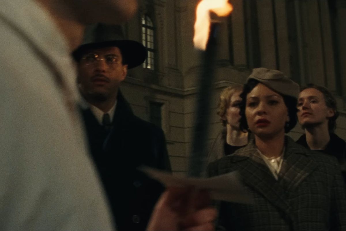 Anthropologists Allison Davis (Isha Blaaker) and Elizabeth Davis (Jasmine Cephas Jones) disturbed as Nazi's march to a book burning in 'Origin.' 