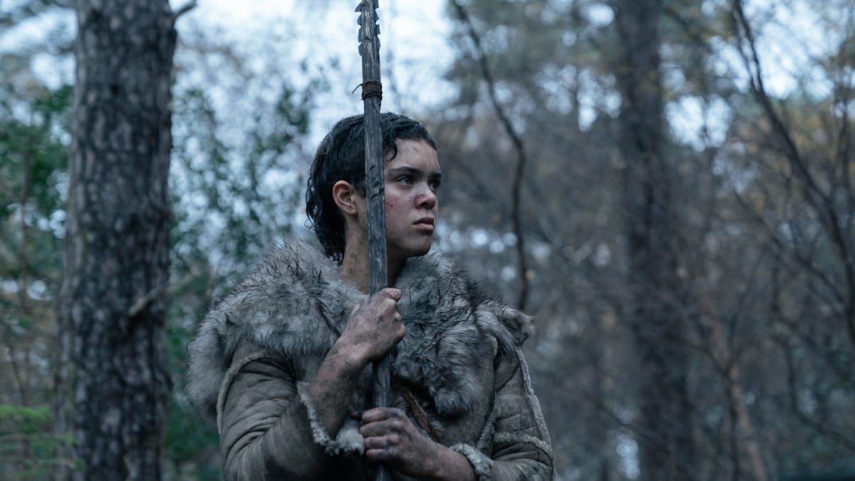 A young stone-age woman holds a spear in 'Out of Darkness'