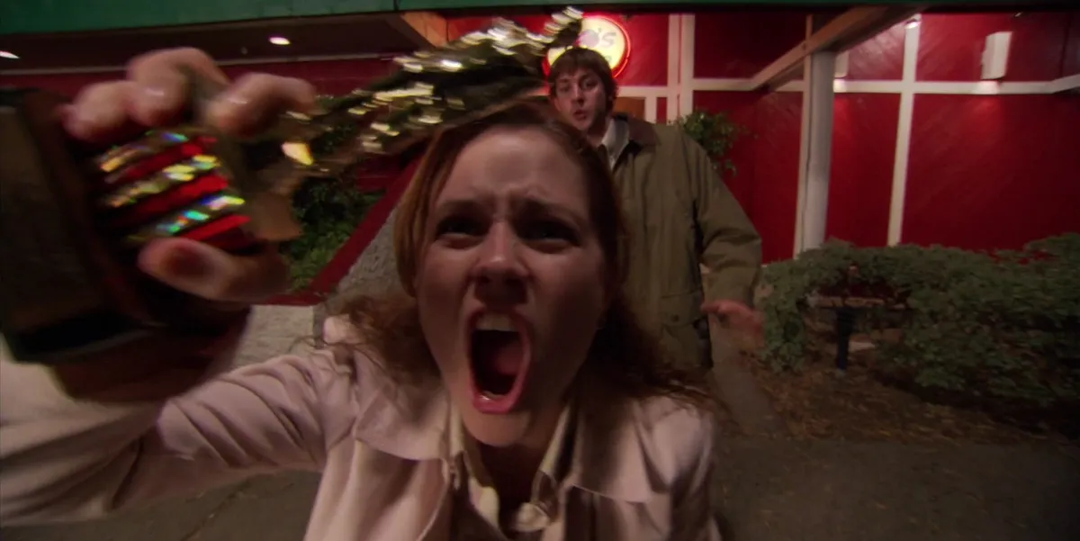Pam (Jenna Fischer) shouting at camera and holding Dundie award