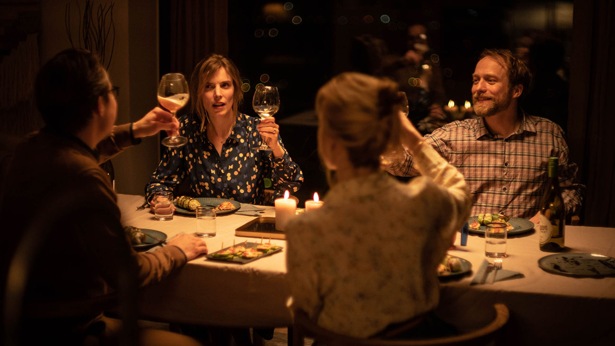 Two couples toast with wine glasses over dinner in 'Speak No Evil'