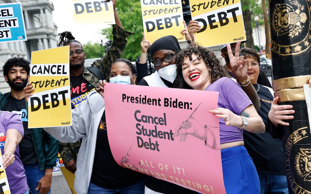 A group of protesters rally for student debt forgiveness.