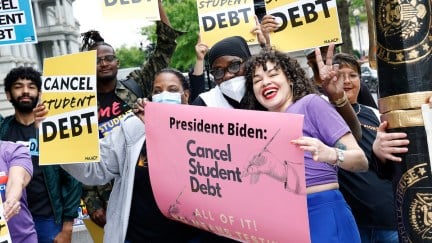 A group of protesters rally for student debt forgiveness.