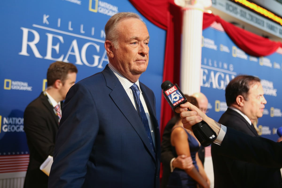 Bill O'Reilly talks to a reporter at an event.