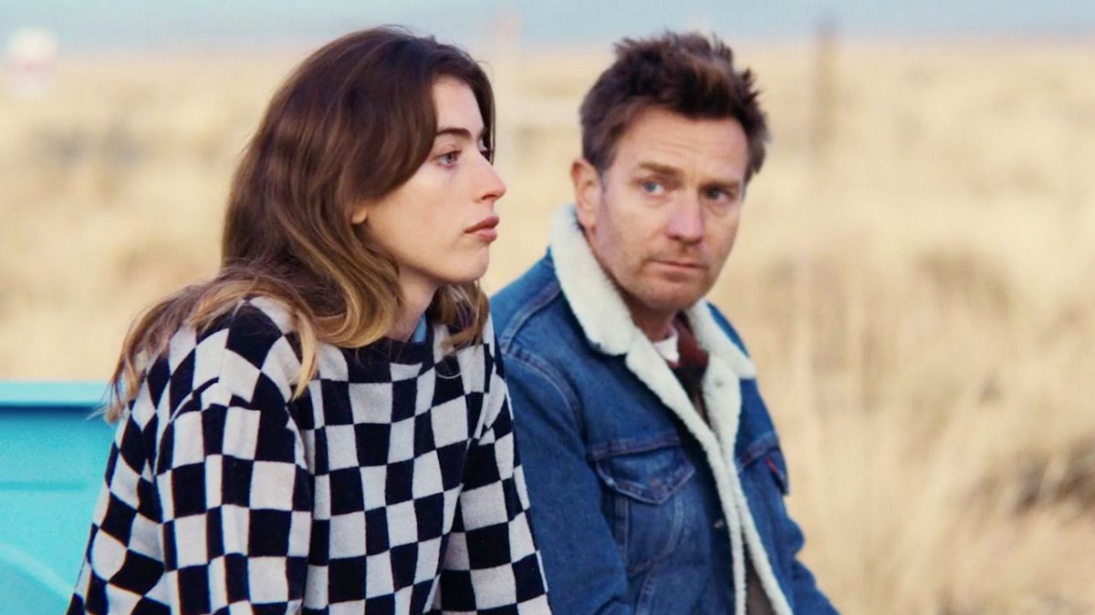 Ewan McGregor and Clara McGregor sitting next to each other in the bed of a truck
