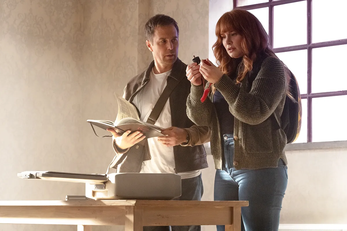 Bryce Dallas Howard and Sam Rockwell standing over a case