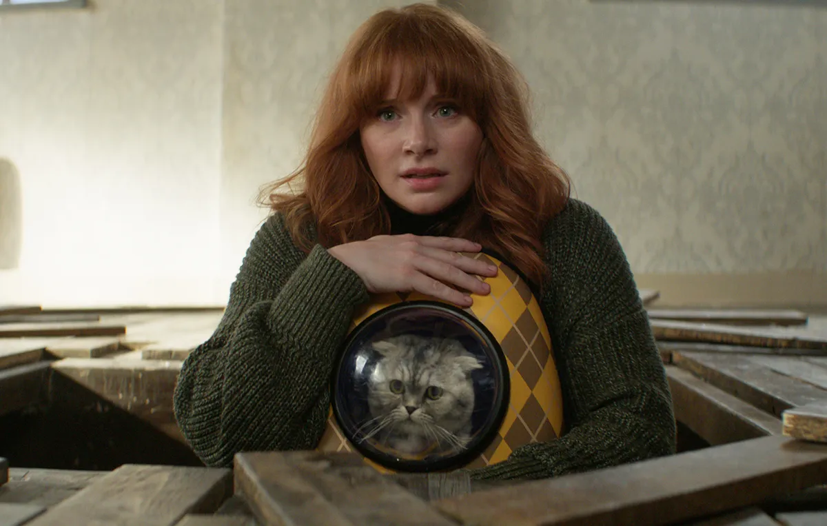 Bryce Dallas Howard holding a cat in a backpack