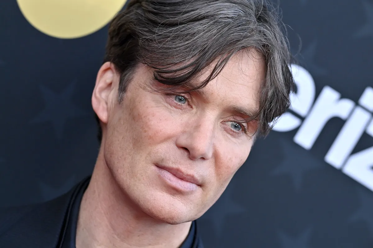 A close-up of Cillian Murphy's face on a red carpet.