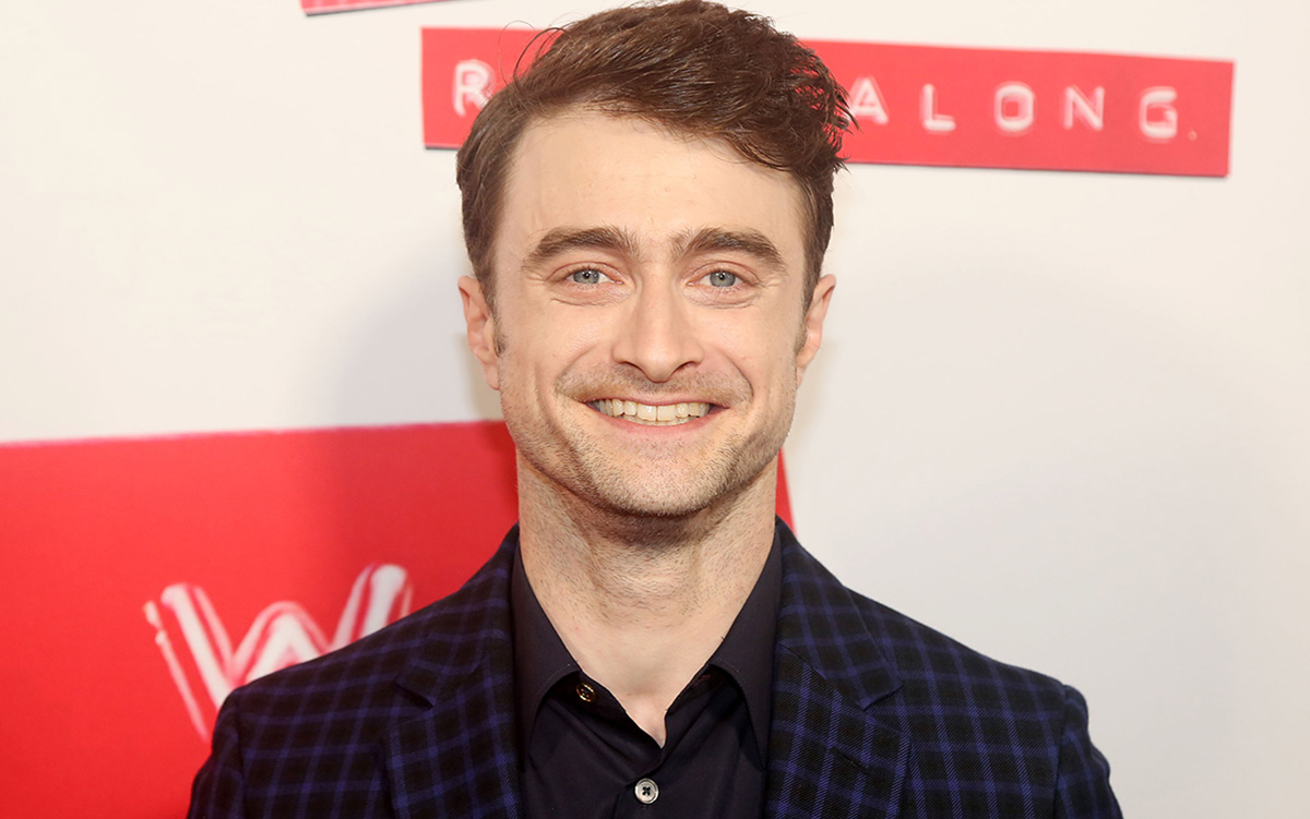 Daniel Radcliffe standing at the opening night of Merrily We Roll Along