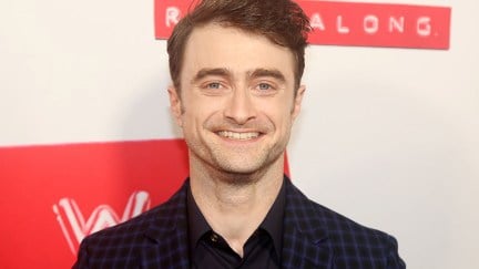 Daniel Radcliffe standing at the opening night of Merrily We Roll Along