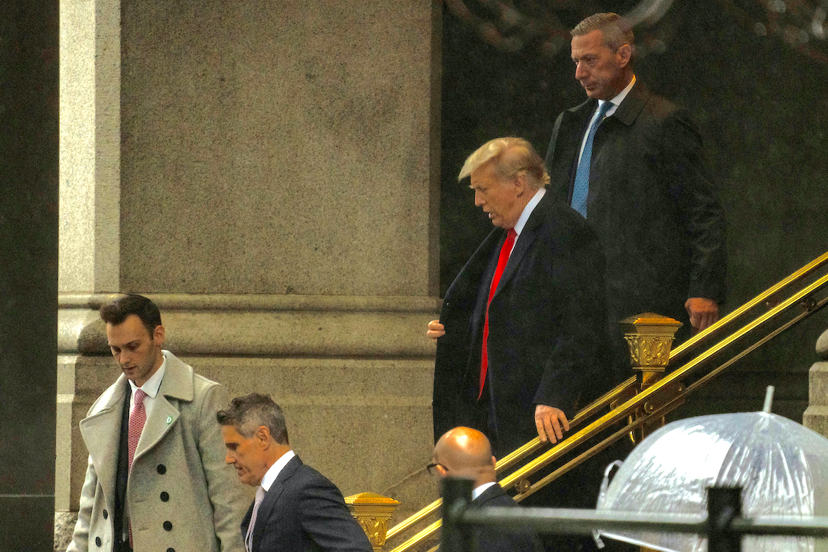 Donald Trump and his lawyers leave a courthouse.